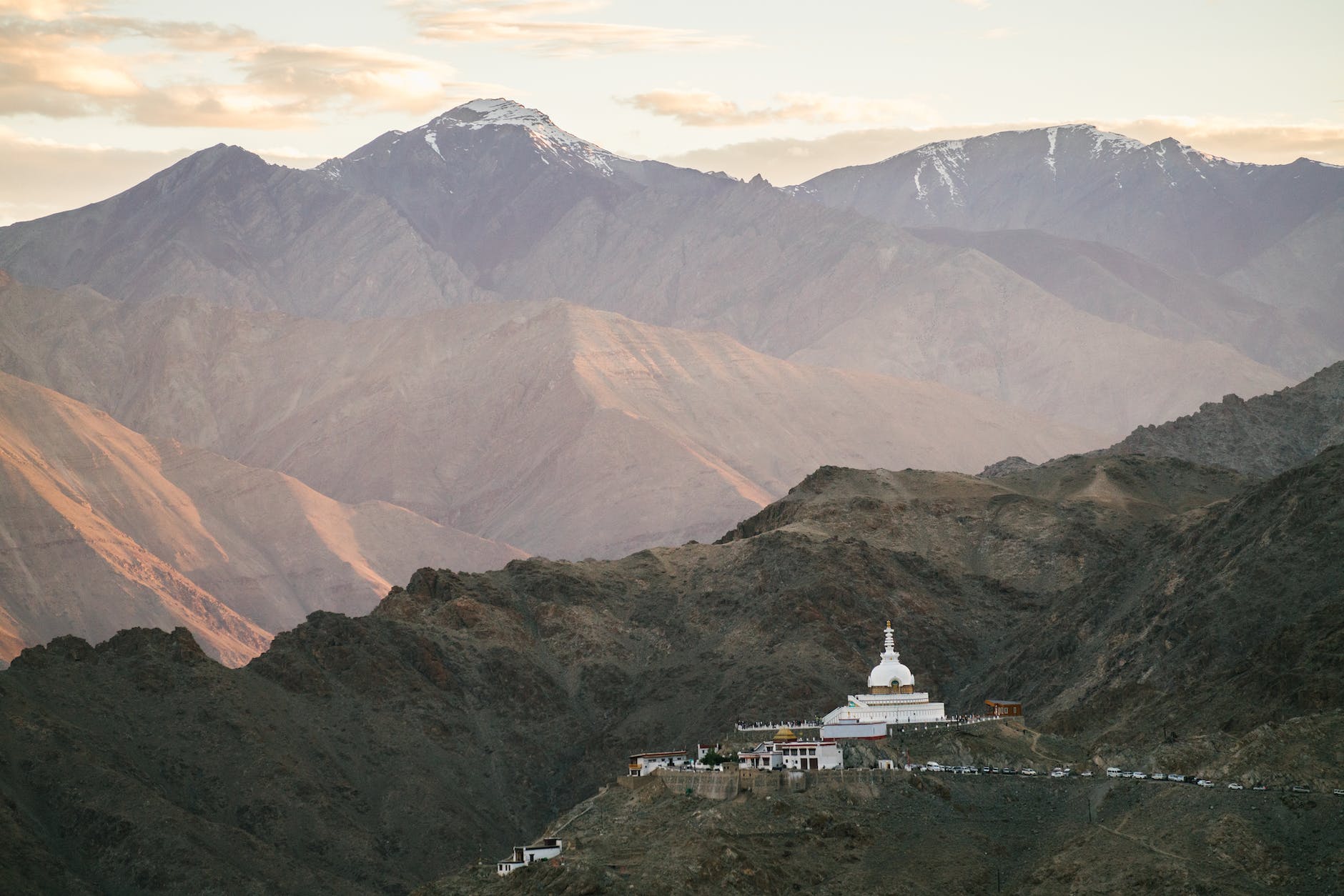 drone shot of shanti stupa and mountains in