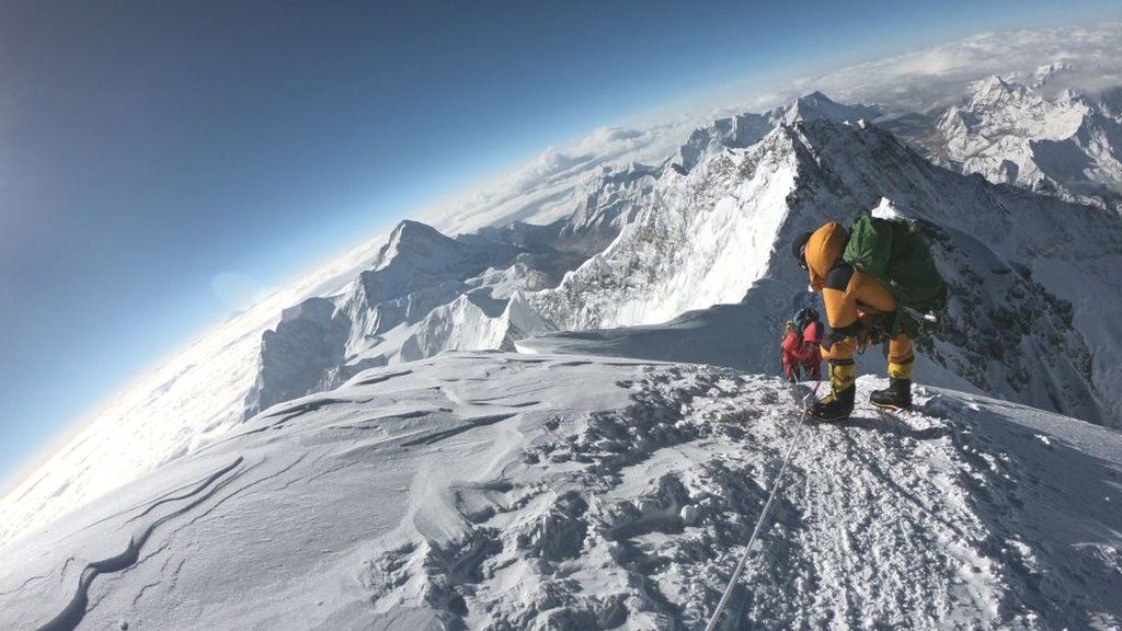 BBC Image of climber climbing to the top of mount Everest. Everest Trekking